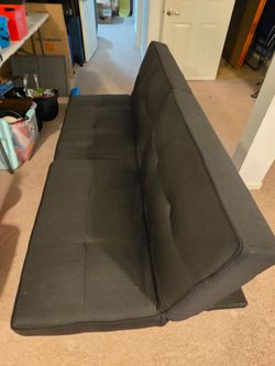 Black tufted futon