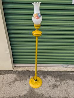 vintage yellow metal floor lamp with a floral glass shade