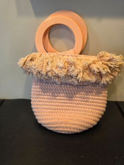 Anthropologie Lara Woven Bucket Bag in a blush pink color