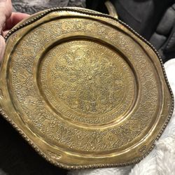 This is a vintage hand-etched brass decorative plate or tray with scalloped rim 