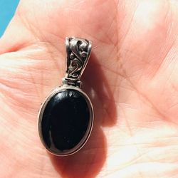 Black onyx oval cabochon pendant set in 925 sterling silver