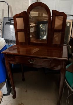 vintage wooden vanity features a distinctive dark finish, tri-fold mirror & panels