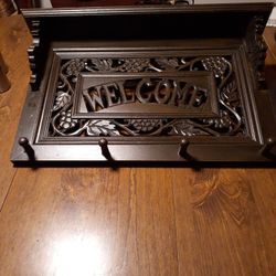 WOODEN  WELCOME COAT RACK WITH SHELF ON TOP  14 INCHES LENGTH AND 2.2 INCHES  WIDE $25.00