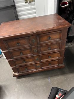 vintage William and Mary-style multi-drawer wooden chest showcases a rich warm wood finish with classic geometric moldings.