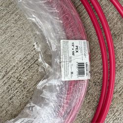 Coil of SharkBite 1/2" x 100' red and blue PEX pipe