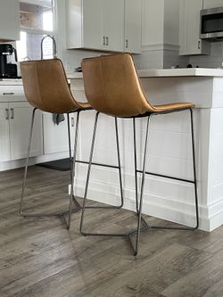 West Elm Real Genuine Leather matching high bar stools (floor to seat: 30”).  In great used condition. Price is for both.