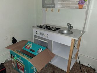 Kids play kitchen with play food and dishes