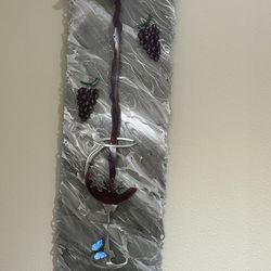 Metal art work with wine glass and grapes