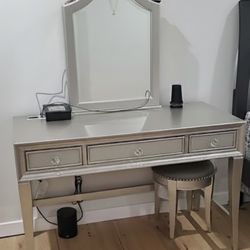 Vanity With Sliding Door Mirror And Hidden Jewelry Behind And Round Stool