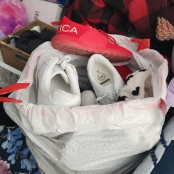 A garbage bag full of shoes sizes 6 And 3