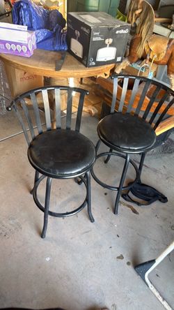 Two black counter height stools