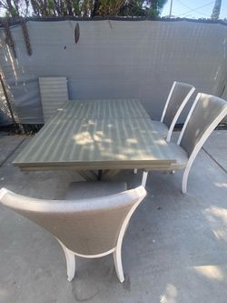 Table with chairs has 8 chairs two are new in box and others ÃŽ have in my back yard