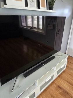 Samsung 75 inch TV with Samsung sound bar and entertainment center