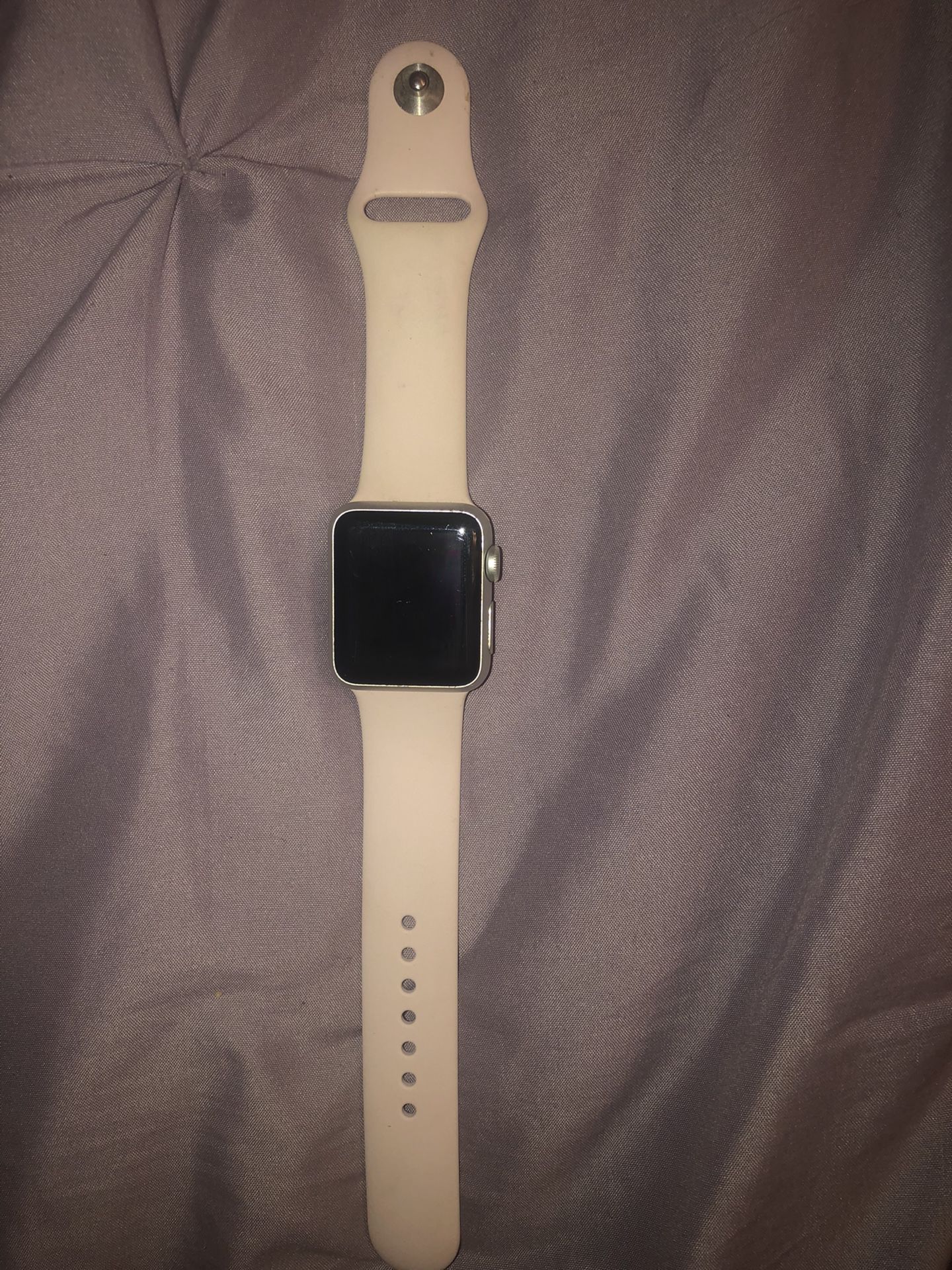 Apple Watch series 1 with both pink and white band and charger