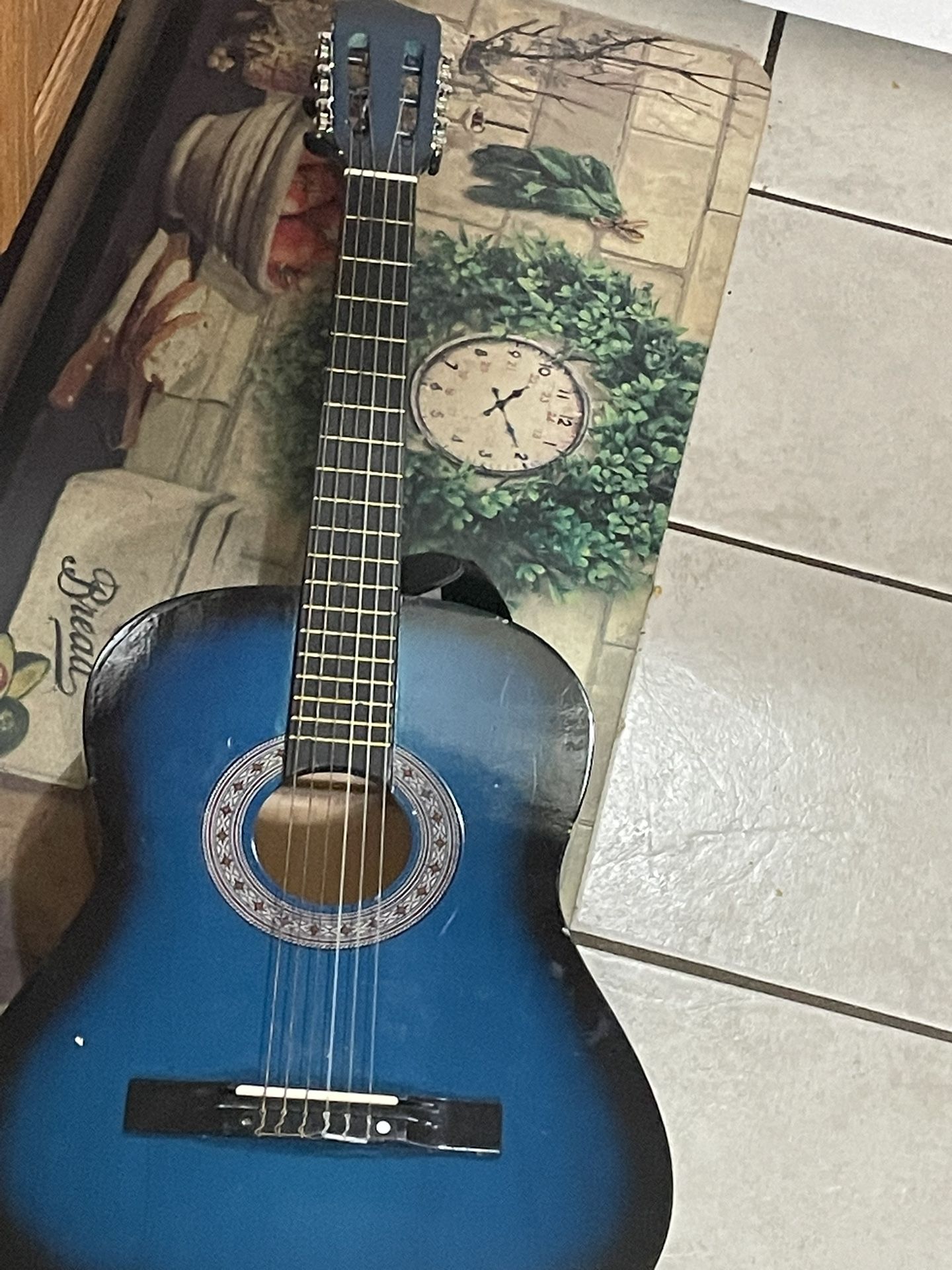 A Guitar For Men And Children Comes With A Strap And A Case For It