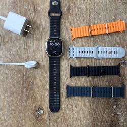 Apple Watch Ultra With Charger And Extra Bands.