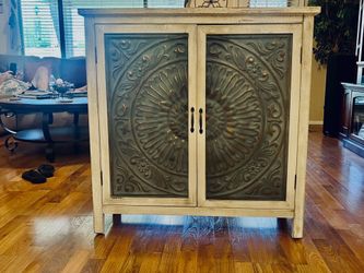 Rustic cabinet with decorative embossed metal doors
