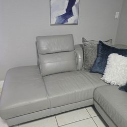 Reclining leather sectional sofa, gray color.