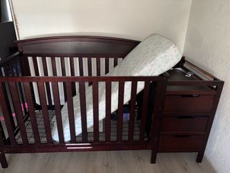 Baby crib with changing table