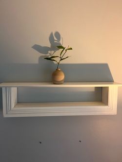 white wooden floating shelf