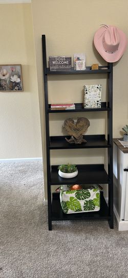 Black leaning book shelf