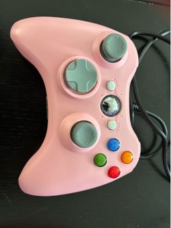 Two wired Xbox 360 controllers pink