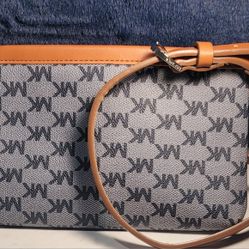 belt bag or fanny pack with a blue logo print canvas and tan leather trim and strap