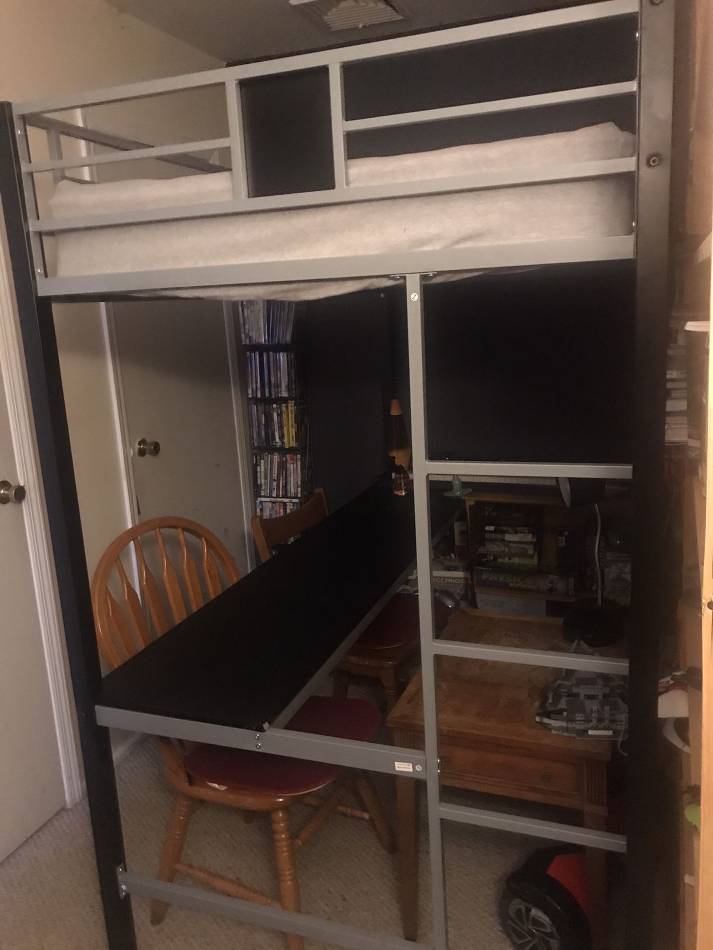 Bunk bed with desk underneath.