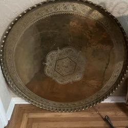 A plate a big silver round plate from India. It's 4 1/2 feet tall all the way around it's brass it's from the late 50s.