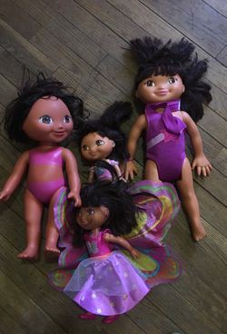 Four Dora dolls & one pillow one stuff Dora