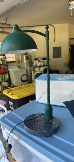 Green metal desk lamp with a Marvel branded base. This lamp has a textured stone-patterned circular base and a curved arm holding a dome-shaped shade.