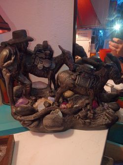 Early settlers with donkey statue