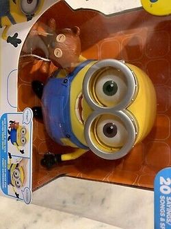 Movie exclusive minion bob interacts with teddy bear new