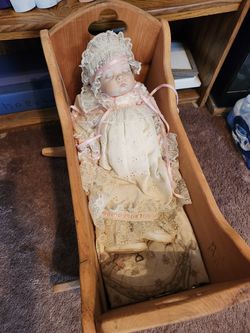 Porcelain doll. Cradle included