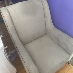 Used beige upholstered wingback accent chair with nailhead trim