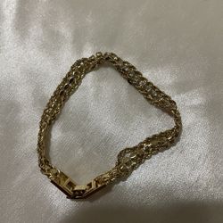 1960’s gold-tone braided chain bracelet with a center row of rhinestones