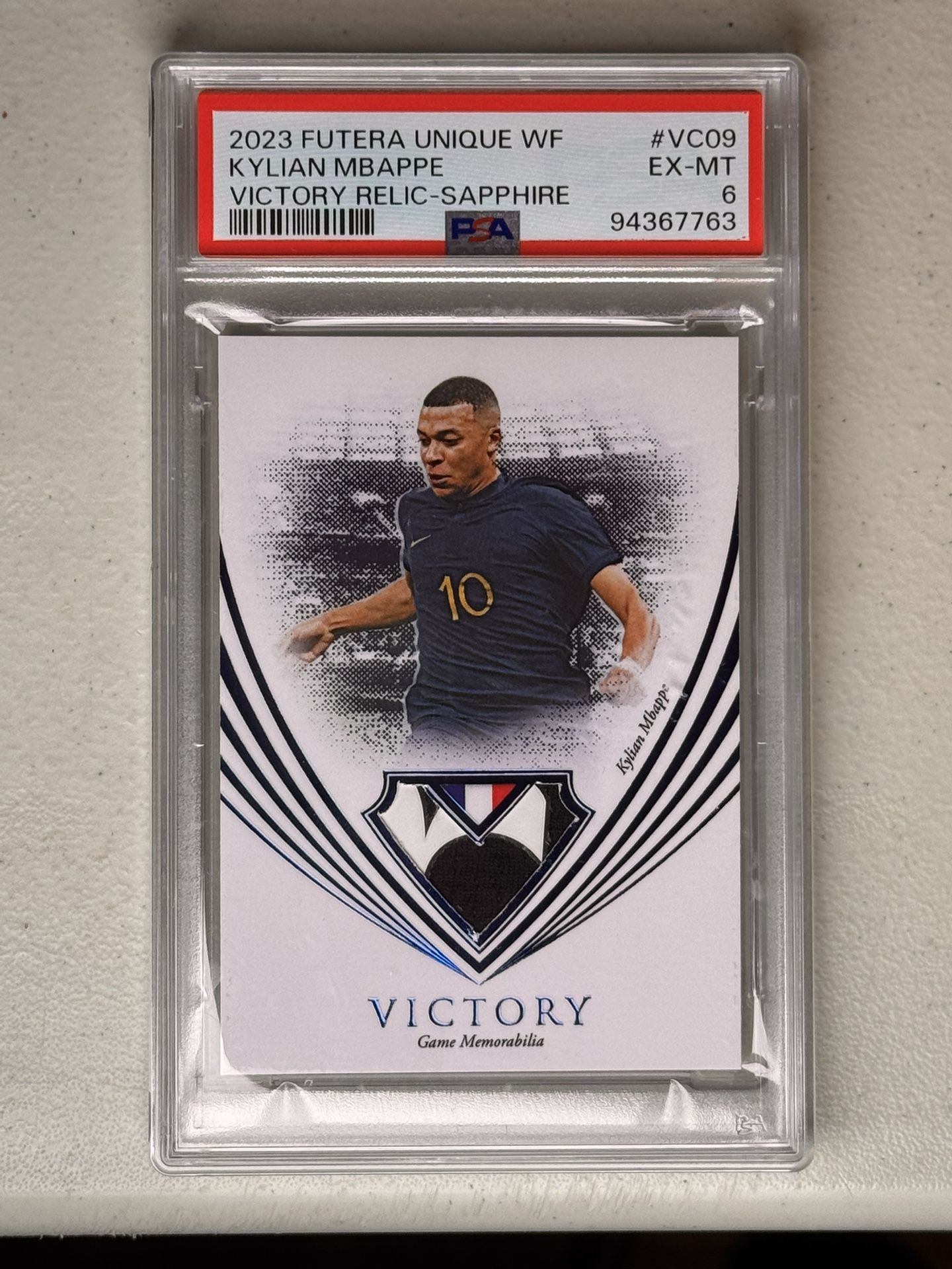 2023 Futera Unique WF Kylian Mbappe Victory Relic Sapphire /10 PSA 6 Game Worn! Edges around patch made it a “6”.