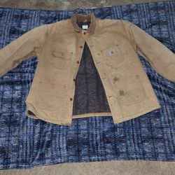 Tan Carhartt jacket with a unique distressed look 