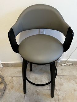 Grey faux leather swivel bar stool with black wood frame