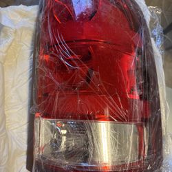 New taillight (tail lamp), in excellent condition, never installed. Includes wiring and connectors. High-quality replacement part, ideal for direct re
