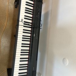 Yamaha Piano with a Chair 