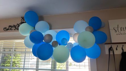 Blue balloon arch and balloons on sticks