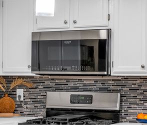 Frigidaire Gallery 30 in. Over-the-Range Microwave in Stainless Steel with Dishwasher Safe Grease Filter and Vent
