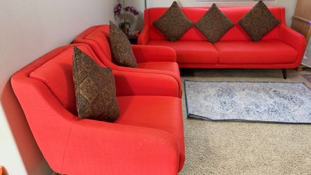 Red upholstered mid-century modern sofa and chair