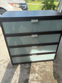 Dark brown 4-drawer dresser with frosted glass drawer fronts and silver bar handle.