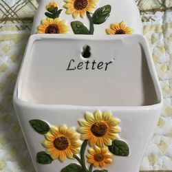 Ceramic napkin and letter holder, with hooks for hanging keys.