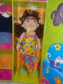 Groovy Girls doll closet set its new with 3 offits as well a flower purse and also a cute little headband great Christmas present