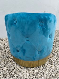 round teal velvet button-tufted ottoman