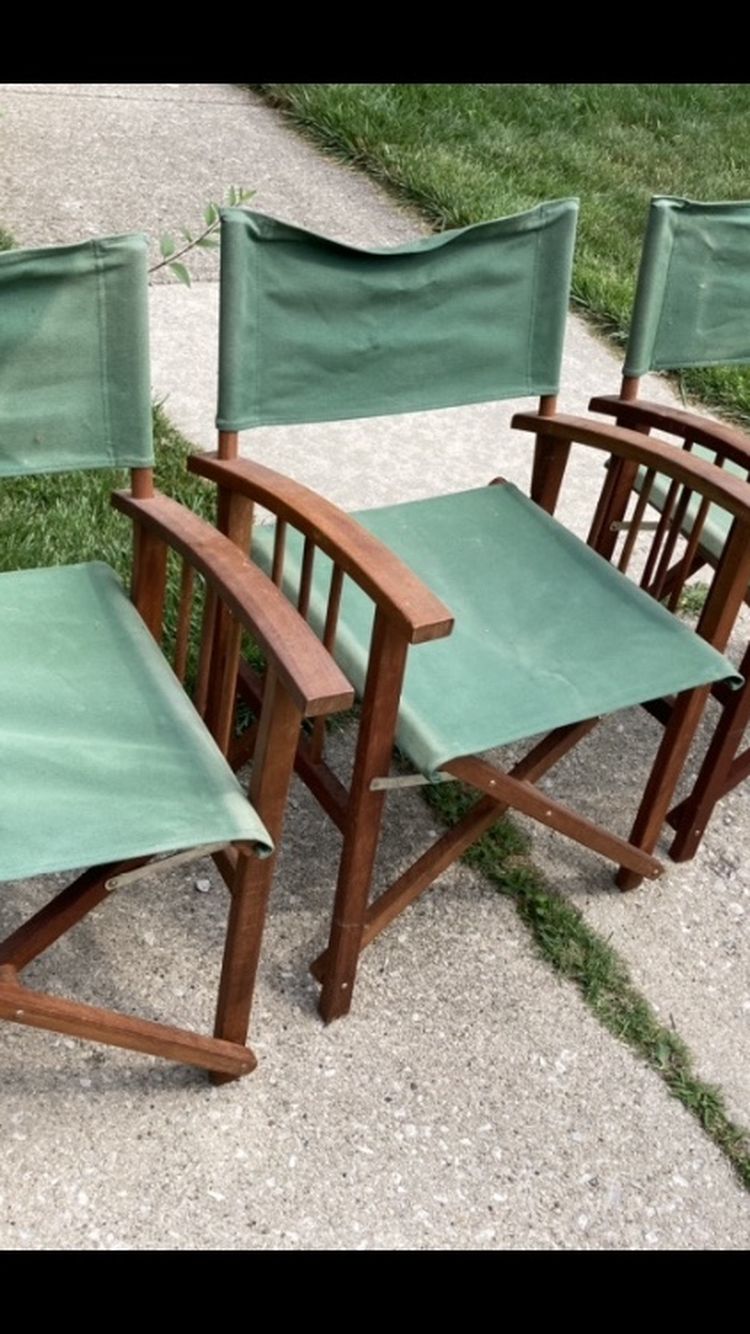 Three green studio directors chairs 