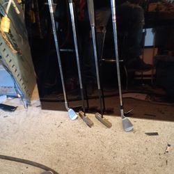 Four Left-handed Golf Clubs Putters And Wedges